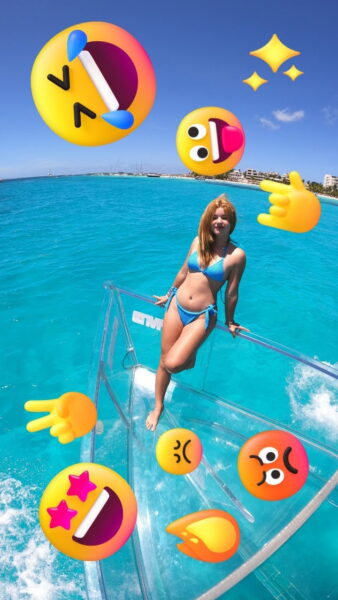 Woman having fun and posing for photos on the top-rated Isla Mujeres clear boat tour.