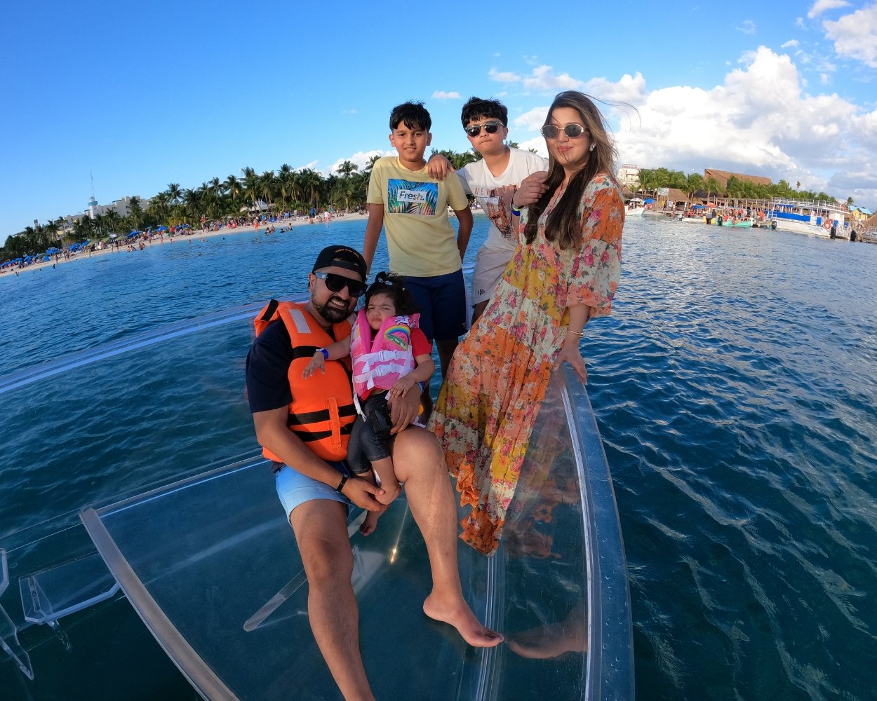 Family aboard a clear boat during an Isla Mujeres vacation