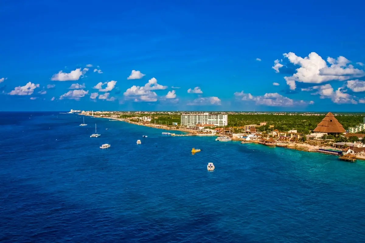 Things to Do in Cozumel During GFNY: 2026 Race Week Guide 1 Cyclists along the Caribbean coast in Cozumel illustrating things to do in Cozumel during GFNY